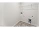 The laundry room features hookups for a washer and dryer, gray tile floor and a wire rack for storage at 110 Cribbs Ln, Middlesex, NC 27557