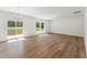 Spacious living room with hardwood floors, chandelier, and sliding door leading to deck at 110 Cribbs Ln, Middlesex, NC 27557