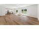 Open floor plan with hardwood floors connecting living room and kitchen with a walkout deck at 110 Cribbs Ln, Middlesex, NC 27557