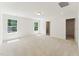 A spacious main bedroom offers neutral carpet, 2 windows and access to the main bathroom at 110 Cribbs Ln, Middlesex, NC 27557