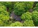 Aerial view of a home completely secluded within mature trees, offering ultimate privacy at 11009 Eaglerock Dr, Raleigh, NC 27613