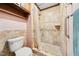 Tiled shower with tiled floors, grab bar, and overhead storage in bathroom at 11009 Eaglerock Dr, Raleigh, NC 27613