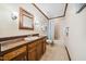 Classic bathroom with wooden vanity, tile floor, framed mirror and bathtub with shower at 11009 Eaglerock Dr, Raleigh, NC 27613