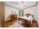 Bedroom featuring hardwood floors, natural light, and classic wood furniture at 11009 Eaglerock Dr, Raleigh, NC 27613