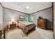 Comfortable bedroom with patterned wallpaper, carpet, and traditional wooden furniture at 11009 Eaglerock Dr, Raleigh, NC 27613
