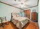 Bedroom with hardwood floors, ceiling fan, closet, and decorative rocking chair at 11009 Eaglerock Dr, Raleigh, NC 27613