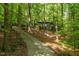 Long driveway leading up to a home nestled among mature trees at 11009 Eaglerock Dr, Raleigh, NC 27613