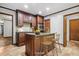 Functional kitchen island featuring barstool seating, granite countertops and stainless steel sink at 11009 Eaglerock Dr, Raleigh, NC 27613