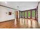Spacious living room with hardwood floors, sconce lighting and many windows at 11009 Eaglerock Dr, Raleigh, NC 27613