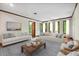Bright living room with neutral decor, large windows, and stylish furnishings at 11009 Eaglerock Dr, Raleigh, NC 27613