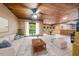 Cozy living room boasts a wood ceiling, white sofa, and a wall of sliding glass doors at 11009 Eaglerock Dr, Raleigh, NC 27613