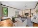 Cozy living room boasts a stone fireplace, hardwood floors, and serene views at 11009 Eaglerock Dr, Raleigh, NC 27613