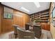 Inviting home office boasts custom built-ins, wood paneling, and a large window with natural light at 11009 Eaglerock Dr, Raleigh, NC 27613