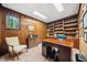 Private home office with wood paneled walls, custom built-in bookshelves and ample lighting at 11009 Eaglerock Dr, Raleigh, NC 27613