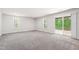 Finished basement features neutral carpet, recessed lighting, two windows, and a sliding door to access the backyard at 1101 Boxcar Way, Apex, NC 27502