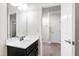 Bathroom featuring a dark vanity with a white countertop and sink, as well as a mirror at 1101 Boxcar Way, Apex, NC 27502