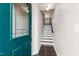 Inviting entryway with beautiful teal front door and staircase leading to the upper level of the home at 1101 Boxcar Way, Apex, NC 27502