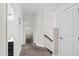 Hallway with carpeted floor and view into an adjacent room and bathroom with dark vanity at 1101 Boxcar Way, Apex, NC 27502
