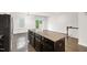 Modern kitchen island with granite counter tops and dark cabinetry with stainless steel appliances at 1101 Boxcar Way, Apex, NC 27502