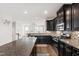 Stylish kitchen with granite island and countertops, stainless steel appliances, and dark wood cabinetry at 1101 Boxcar Way, Apex, NC 27502