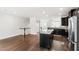 Bright open floor plan with kitchen island, stainless steel appliances, and dark cabinets at 1101 Boxcar Way, Apex, NC 27502
