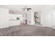 Spacious living room with neutral carpet, ceiling fan and stairs leads up to the bedrooms at 1101 Boxcar Way, Apex, NC 27502