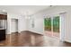 Open living space with sliding doors to the deck, bright light, and view of stainless steel kitchen appliances at 1101 Boxcar Way, Apex, NC 27502