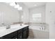 Spacious main bathroom with double sink vanity, soaking tub, and tile flooring at 1101 Boxcar Way, Apex, NC 27502