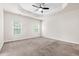 Spacious main bedroom features neutral carpet, a ceiling fan, and two windows at 1101 Boxcar Way, Apex, NC 27502