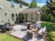 Landscaped backyard patio features modern outdoor furniture and barbecue area, ideal for gatherings and relaxation at 1103 Capstone Dr, Durham, NC 27713