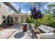 Inviting backyard patio featuring an outdoor seating area and grill, perfect for relaxation and entertainment at 1103 Capstone Dr, Durham, NC 27713