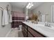 Bathroom features a double sink vanity, decorative accents, and shower with attractive privacy curtain at 1103 Capstone Dr, Durham, NC 27713