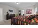 Bedroom featuring a large bed with colorful quilt, dresser and a view into the bathroom at 1103 Capstone Dr, Durham, NC 27713