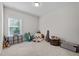 Neutral bedroom filled with plush toys and a large window providing natural light at 1103 Capstone Dr, Durham, NC 27713