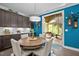 Dining area with a wooden table and seating for four, with views of the kitchen and patio at 1103 Capstone Dr, Durham, NC 27713