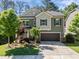 Charming two-story home featuring a manicured lawn and attached two-car garage in a suburban neighborhood at 1103 Capstone Dr, Durham, NC 27713