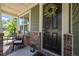 Inviting front porch with dark front door adorned with a floral wreath at 1103 Capstone Dr, Durham, NC 27713