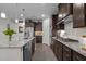 Modern kitchen featuring granite countertops, stainless steel appliances, and dark wood cabinetry at 1103 Capstone Dr, Durham, NC 27713