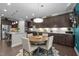 Eat-in kitchen with a wooden table and seating for four, with views of stainless appliances and custom cabinets at 1103 Capstone Dr, Durham, NC 27713