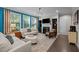 Bright living room with a fireplace, hardwood floors, large windows, and comfortable seating at 1103 Capstone Dr, Durham, NC 27713
