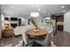 Open-concept living space featuring a fireplace, hardwood floors, and a dining area with seating for four at 1103 Capstone Dr, Durham, NC 27713