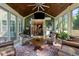 Bright sunroom with floor-to-ceiling windows, comfortable seating, and a wooden ceiling fan at 1103 Capstone Dr, Durham, NC 27713
