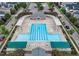 Aerial view showcasing a community pool with lap lanes, lounge areas, and lush landscaping at 1104 Dominion Hill Dr, Cary, NC 27519