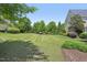 Large, well-maintained backyard with mature trees and manicured landscaping at 1104 Dominion Hill Dr, Cary, NC 27519