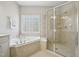 Bathroom with tile flooring, a soaking tub, and glass shower providing a serene space at 1104 Dominion Hill Dr, Cary, NC 27519