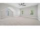Bedroom includes three windows, a ceiling fan, and plush neutral carpeting for comfort at 1104 Dominion Hill Dr, Cary, NC 27519