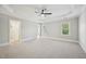 Large primary bedroom boasts tray ceilings, plush carpet, and a walk-in closet, offering style and comfort at 1104 Dominion Hill Dr, Cary, NC 27519