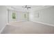 Spacious bedroom featuring tray ceilings, neutral walls and carpet, and abundant natural light from two windows at 1104 Dominion Hill Dr, Cary, NC 27519