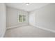 This bedroom features neutral carpet, a double closet and a large window to let in natural light at 1104 Dominion Hill Dr, Cary, NC 27519