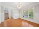 Charming dining room with hardwood floors, wainscoting, and large window at 1104 Dominion Hill Dr, Cary, NC 27519